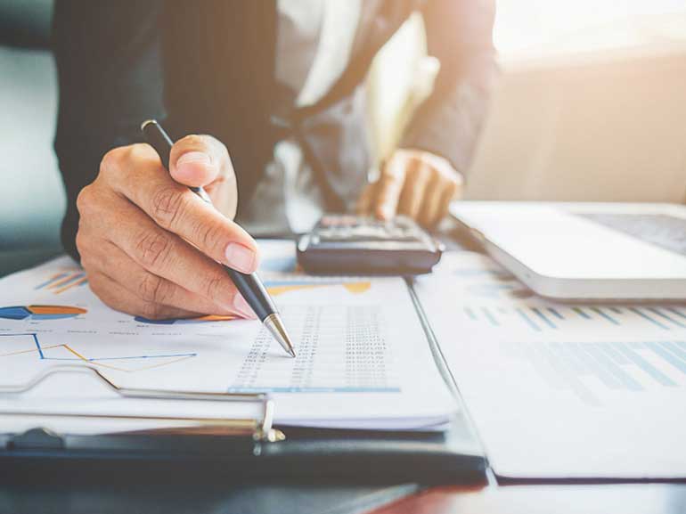 A business associate checking financial reports and charts