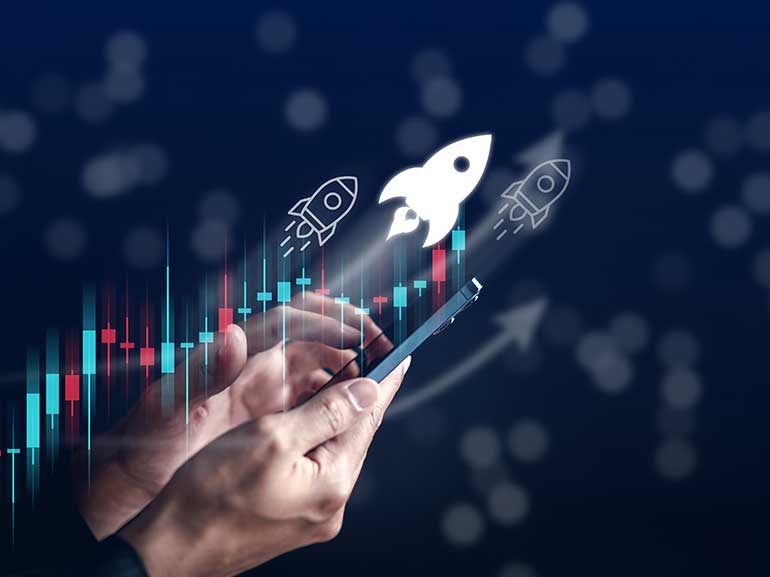 Charts skyrocketing over a man holding a phone