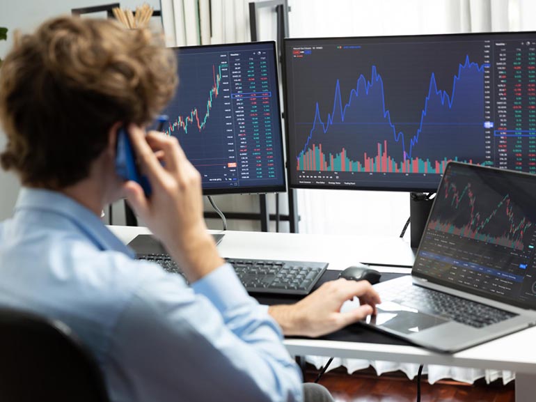 Investor analyzing digital financial charts