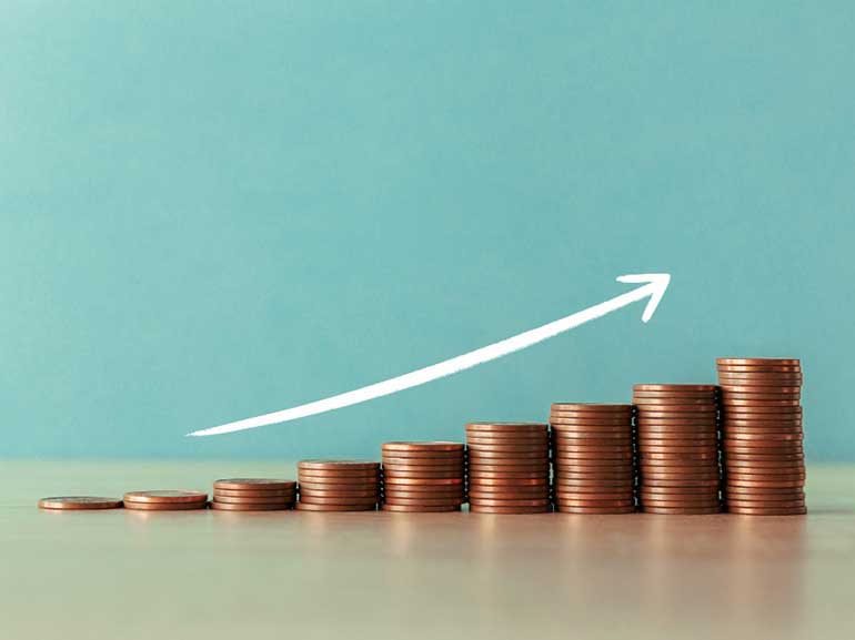 Staircase of coins with an arrow pointing upward