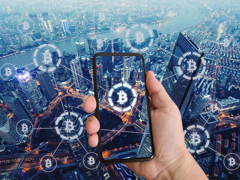 Bitcoin network through phone screen with urban background