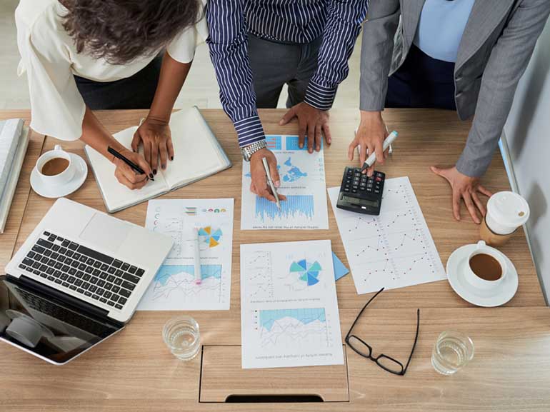 Business people analyzing data reports
