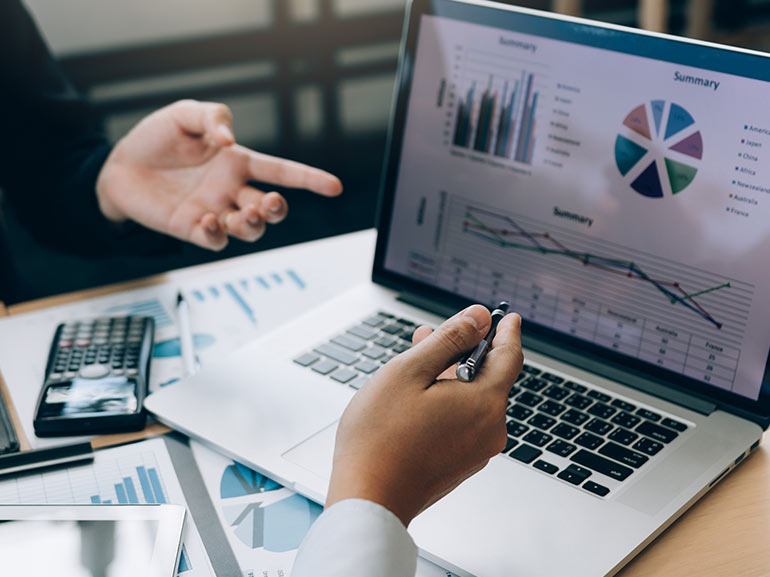 an image of a laptop with trading charts
