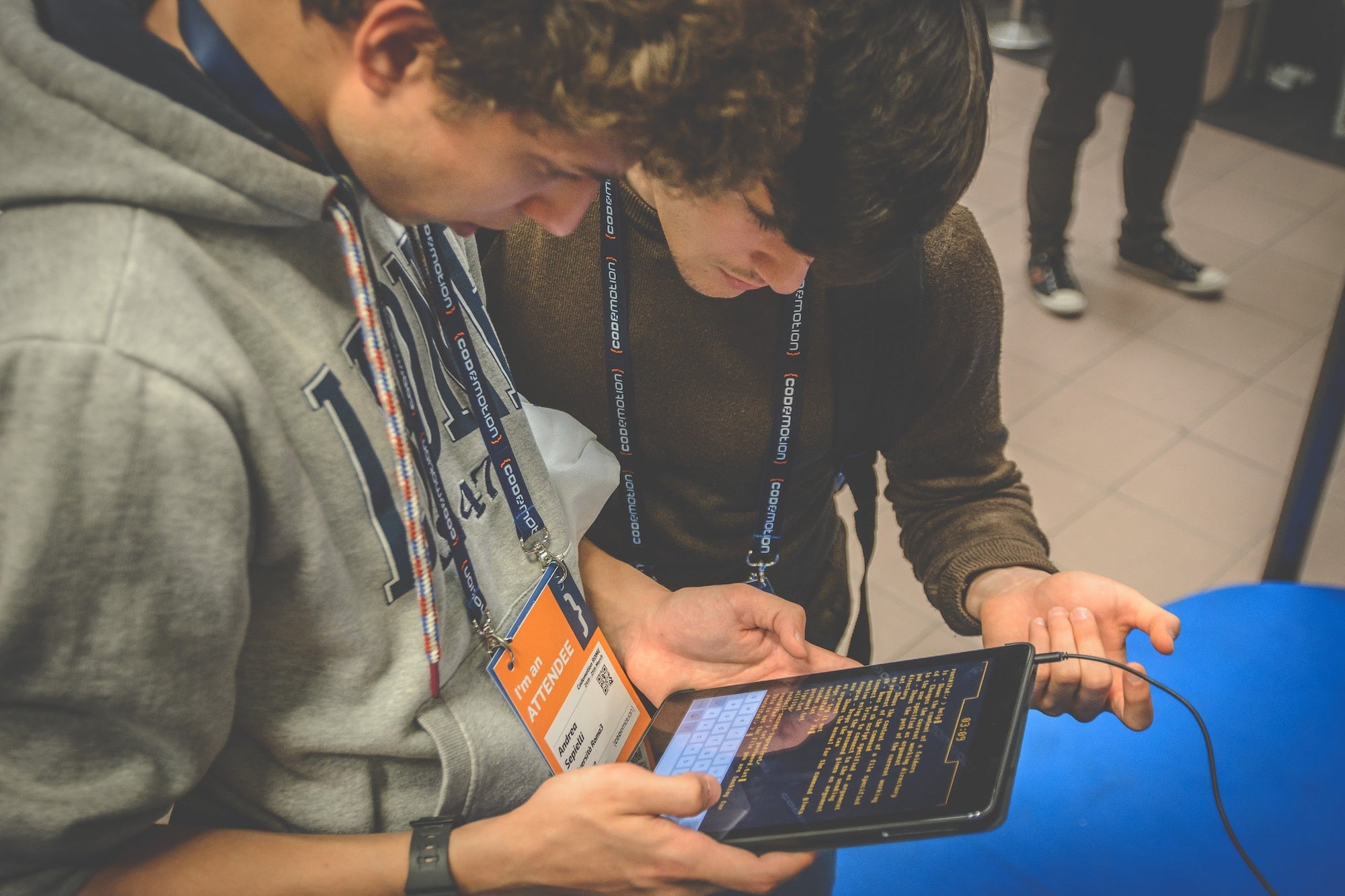 Young man playing with an iPad the Red Bull hacking experience