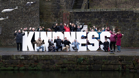 contact-us-community-gathered-around-kindness-sign-by-canal-integrate-todmorden The Todmorden community gathered around a big sign that says kindness