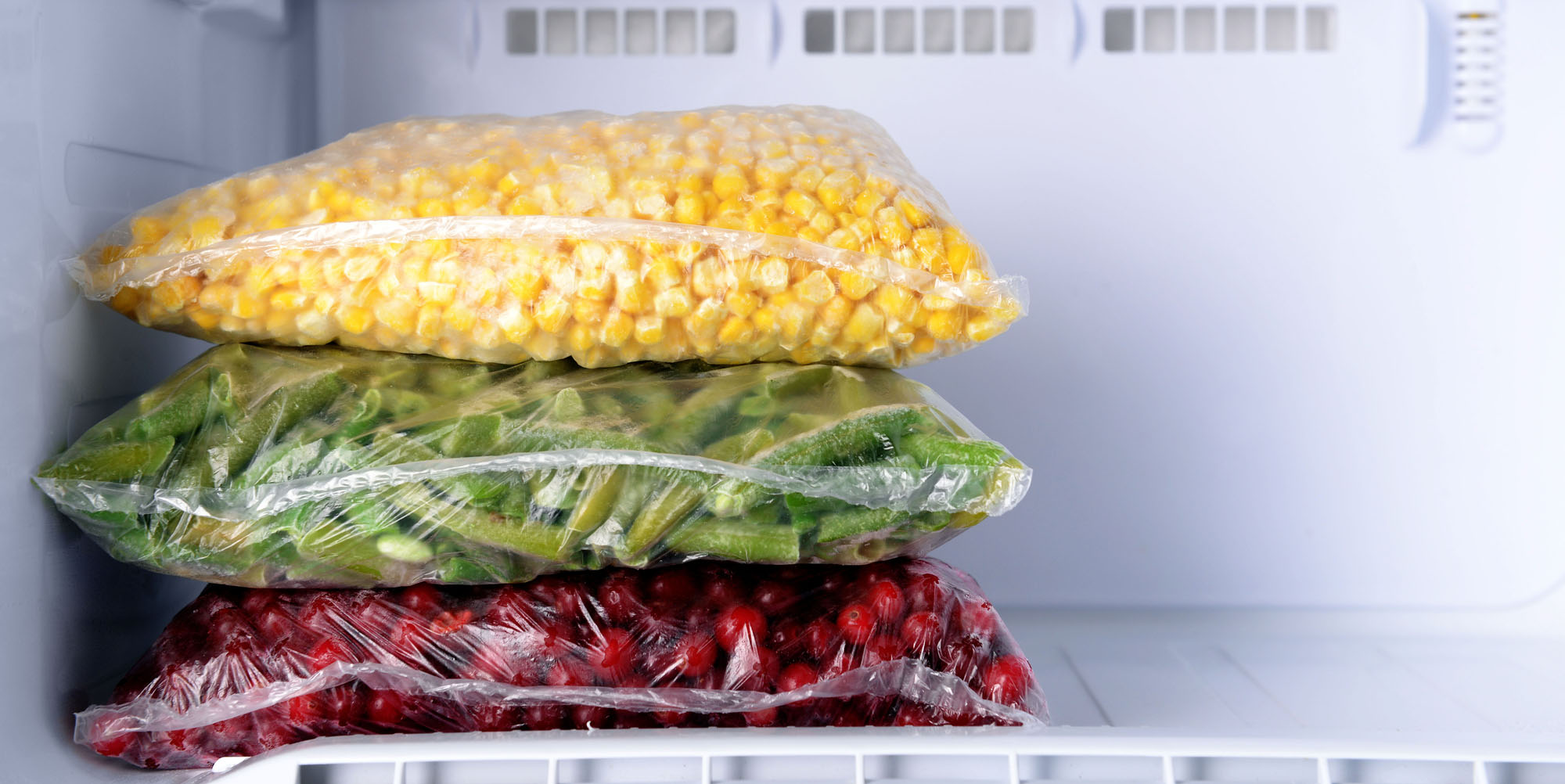 freezer bags with frozen corn beans and cranberries