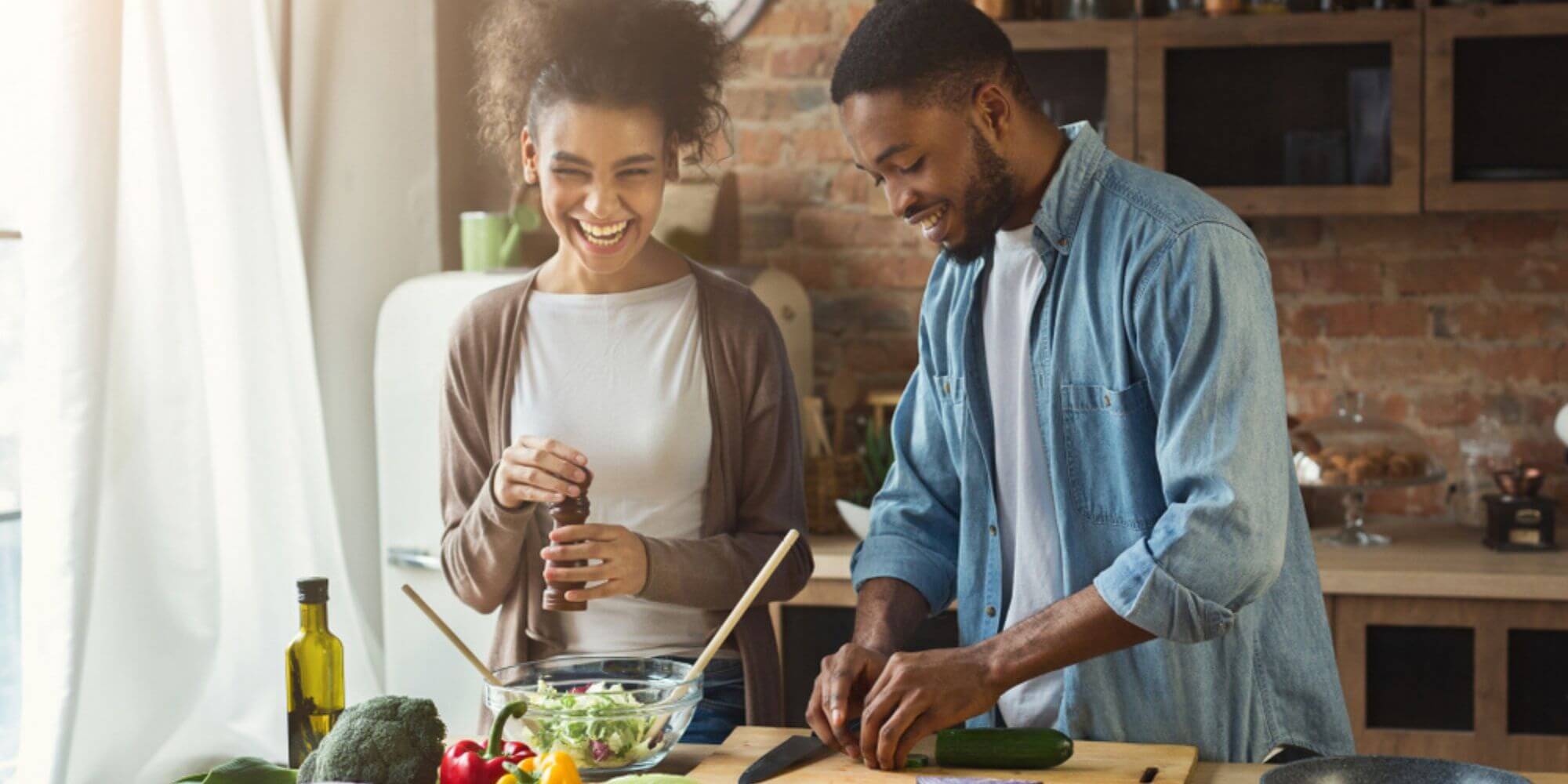Young couple cooks a healthy meal together in their kitchen