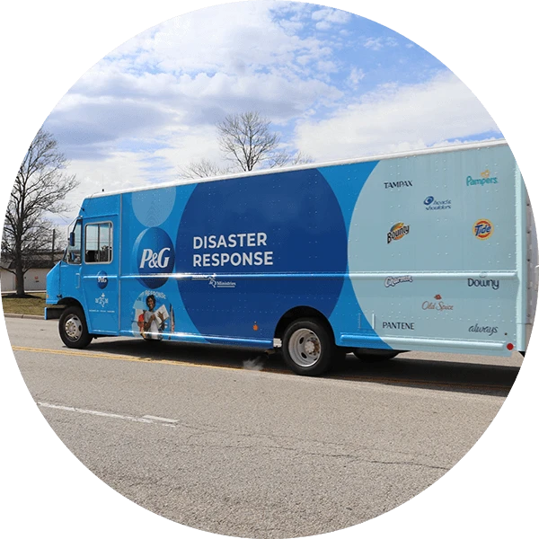 Blue truck with P&G logo and 'DISASTER RESPONSE' title, featuring logos of various P&G brands.