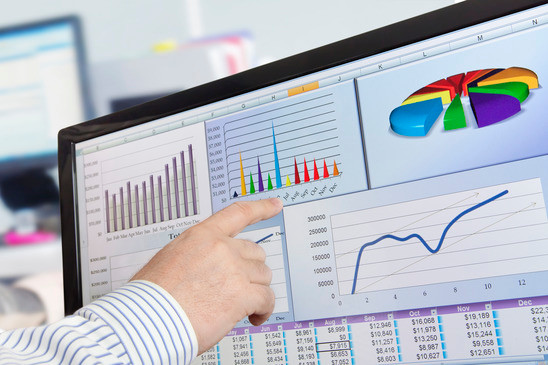 Finger pointing at digital stock chart.