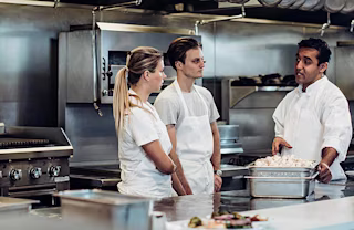 Millennials learning from a chef.