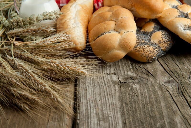 Wheat and bread on table