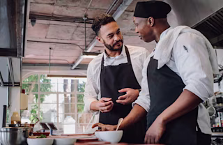 Two employees talking in the kitchen