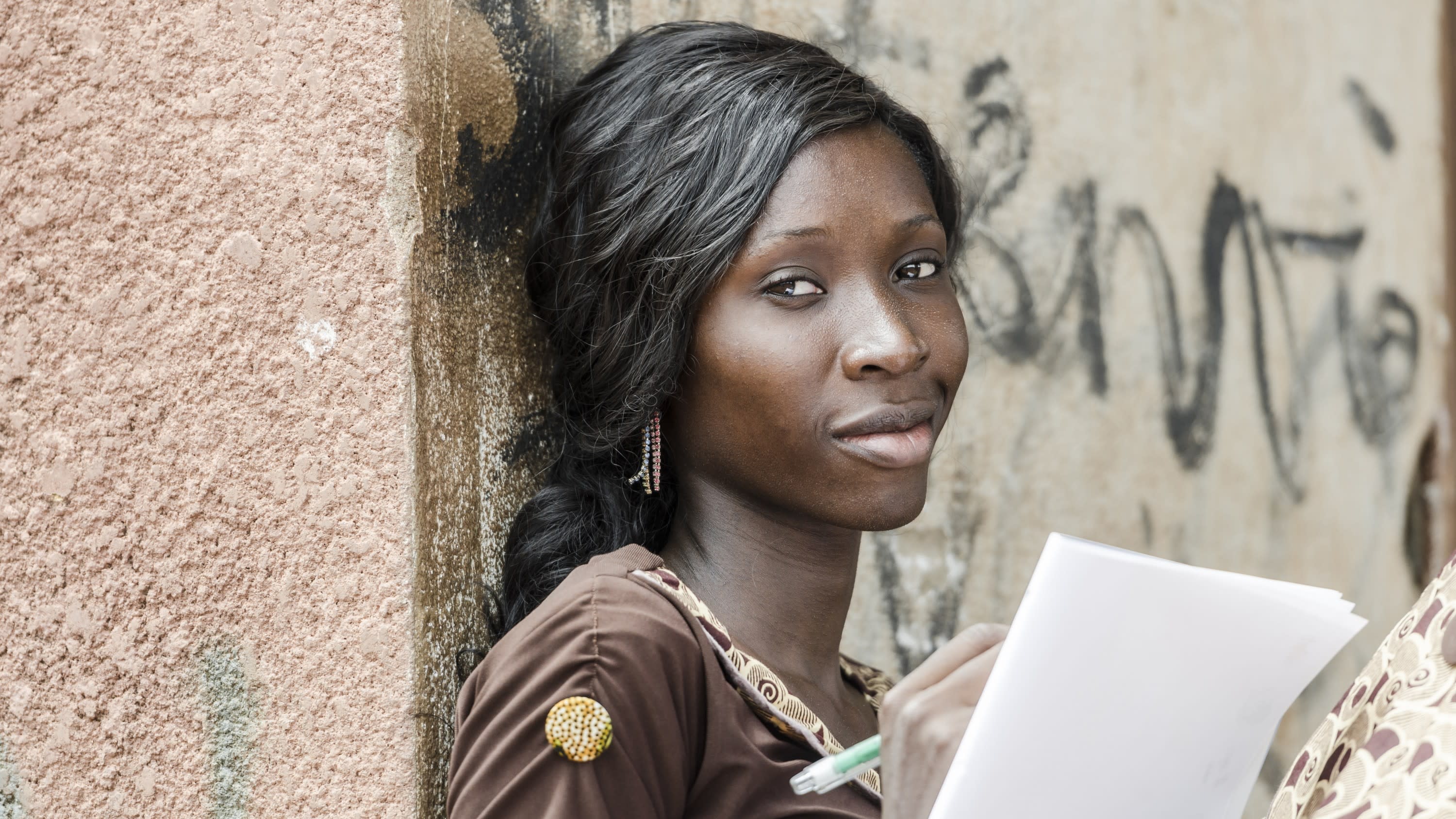 woman leaning against a wall