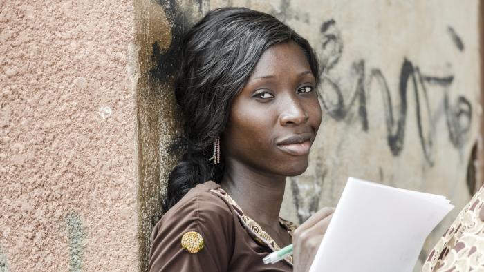 woman leaning against a wall