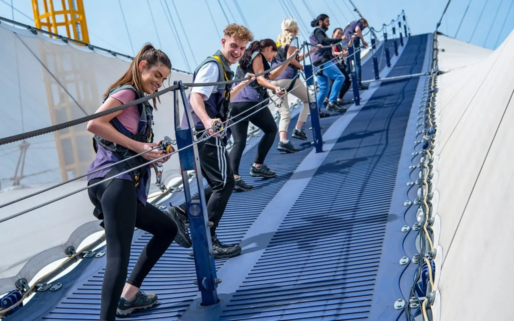 An image showing people climbing the O2 in London