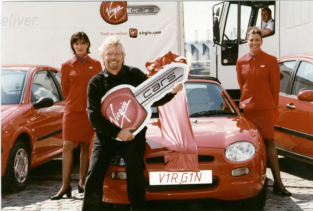 Richard Branson holding a novelty 'Virgin Cars' key 