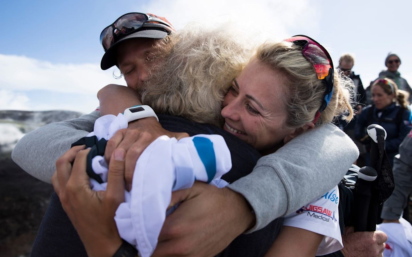 Richard Branson hugging Holly Branson and Sam Branson during the 2016 Strive Challenge