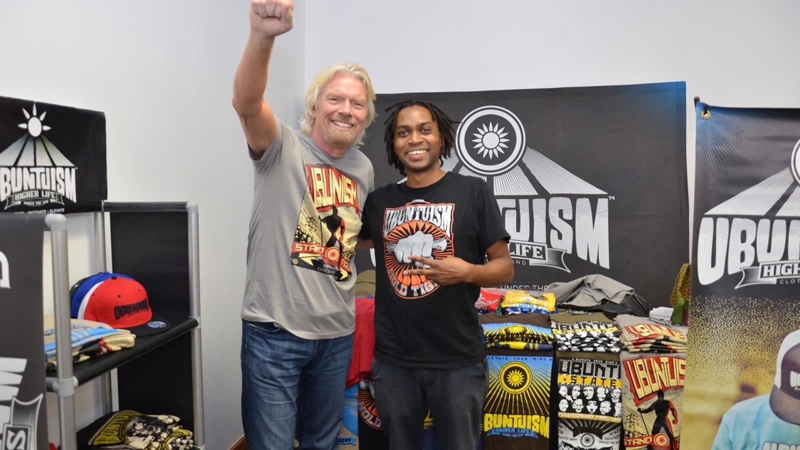 Richard Branson and man with Unbuntuism slogan shirt with surrounding merchandise