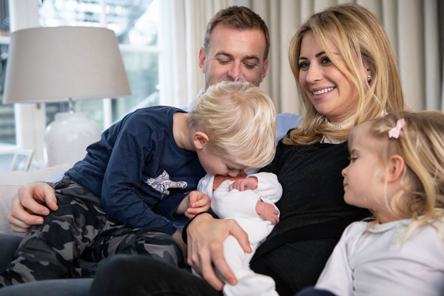 Holly Branson and her husband Freddie Andrewes smile with their three children