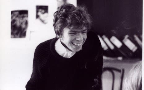 Black and White image of Richard Branson as a student. Smiling in his office