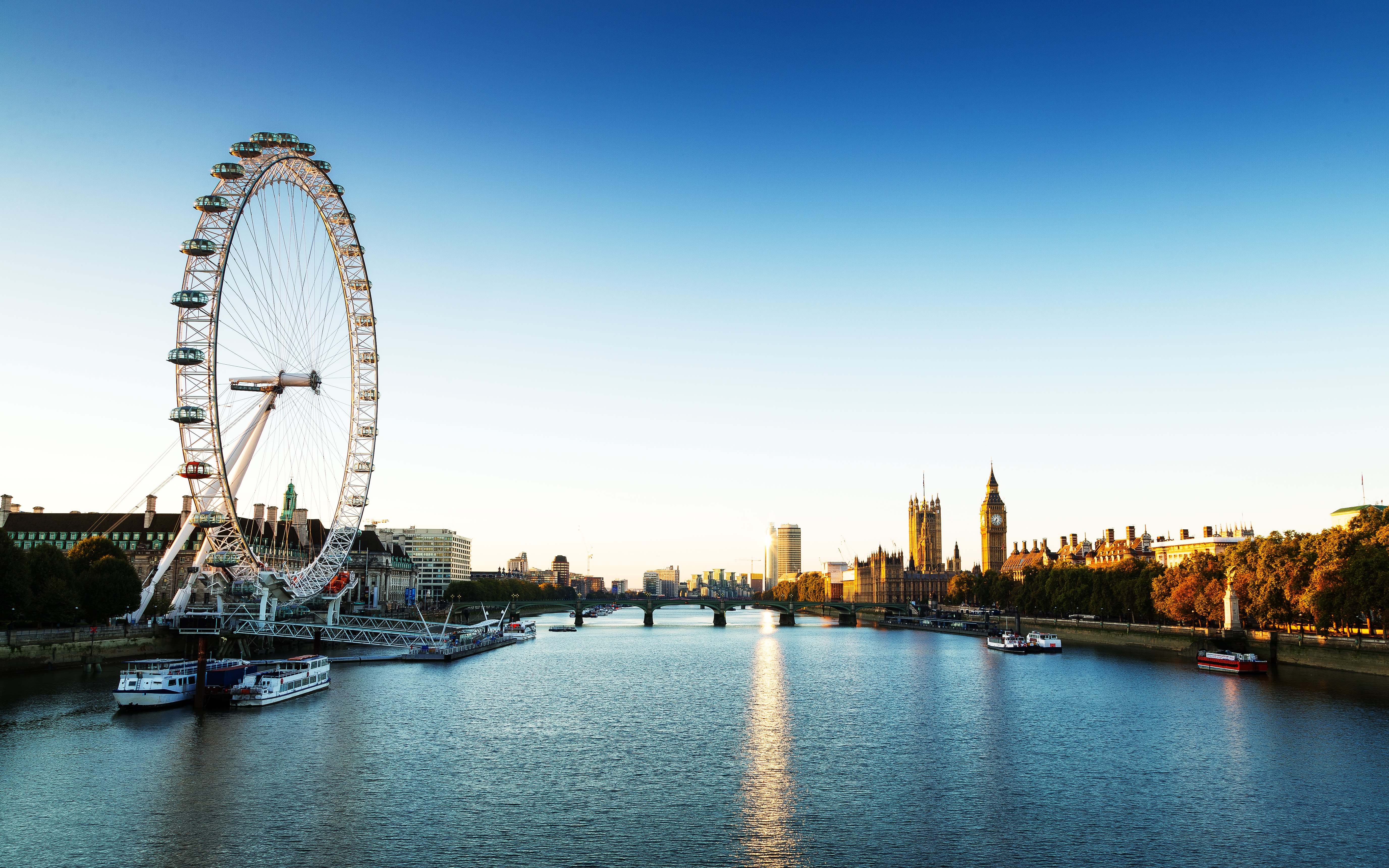 An image of the River Thames with the London Eye and the Houses of Parliament in view.