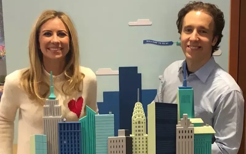 Holly Branson stands next to a small model of New York