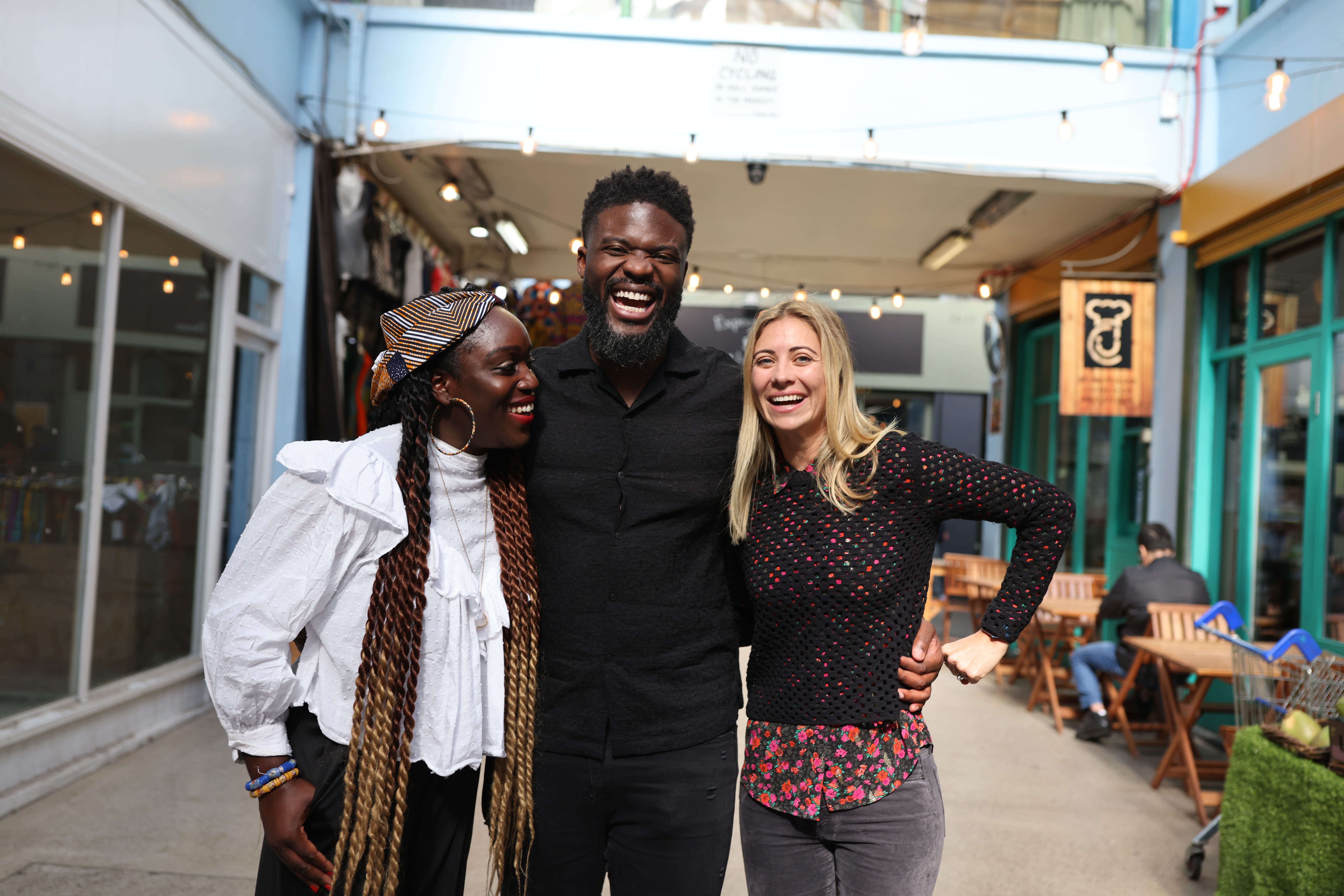Holly Branson smiling with Karl Lokko and Lola Cawood of Black Seed Ventures and Tiwani Heritage in Brixton Village