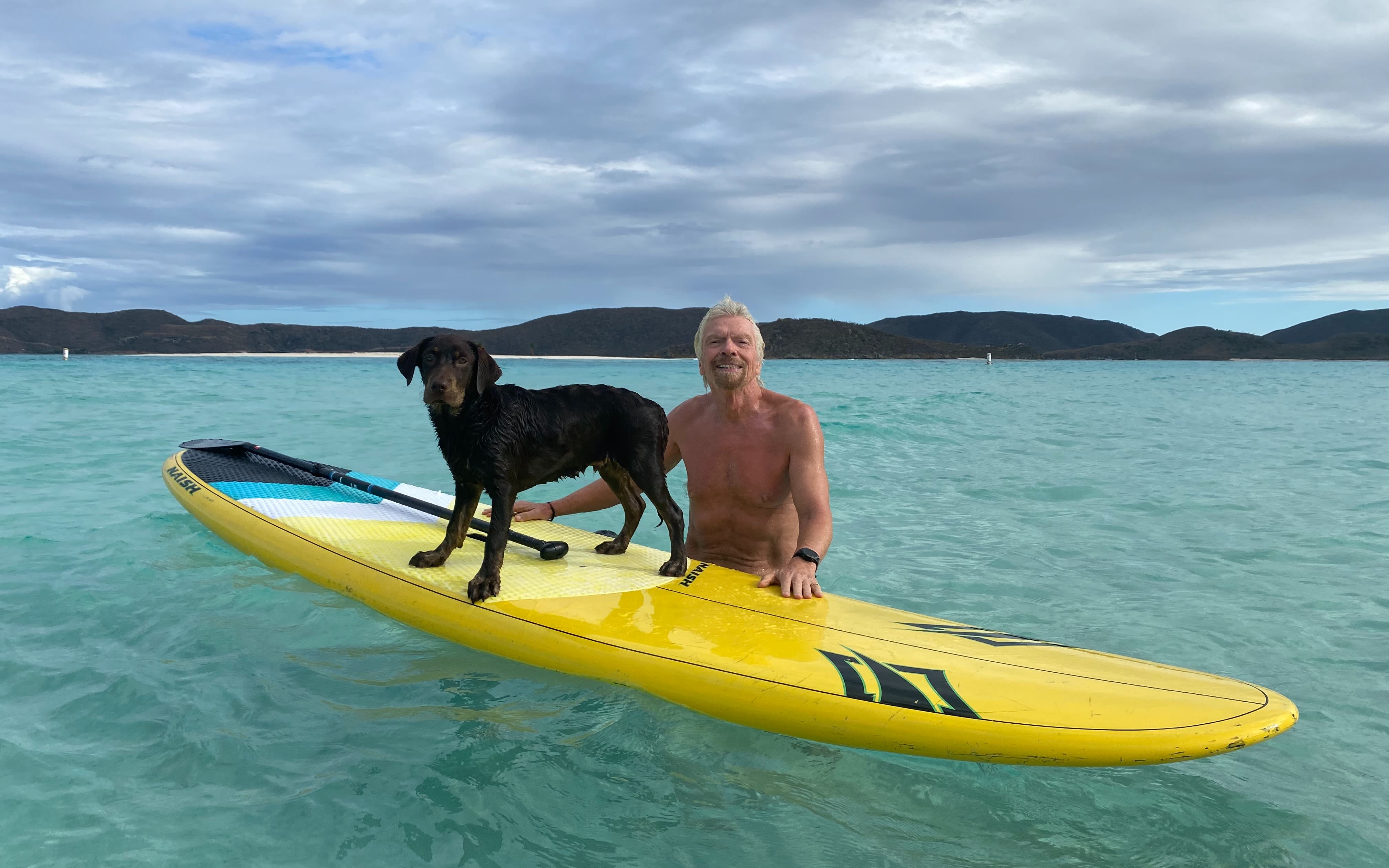 Richard Branson teaches his new puppy to swim