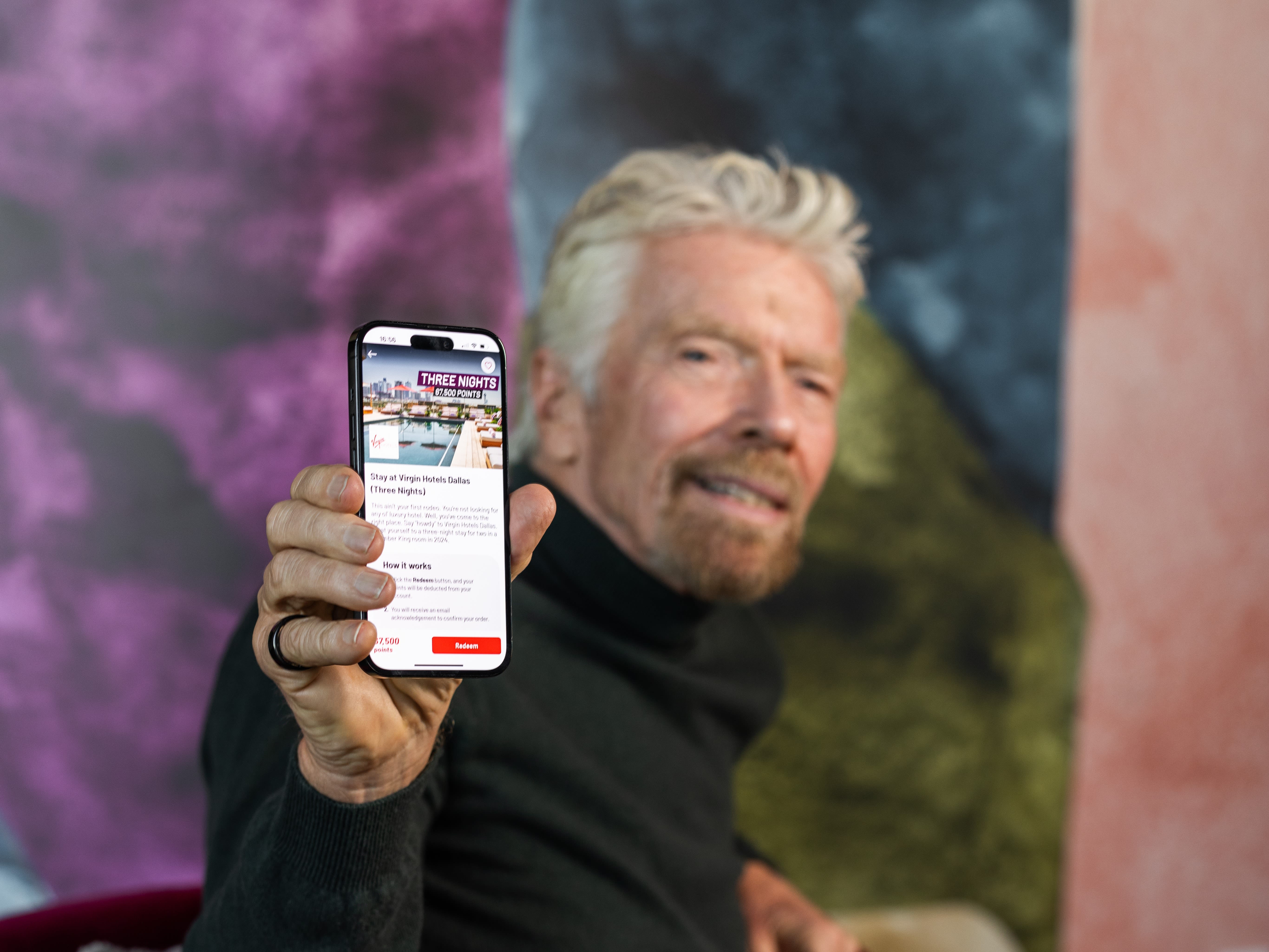 Richard Branson looking at the Virgin Red app