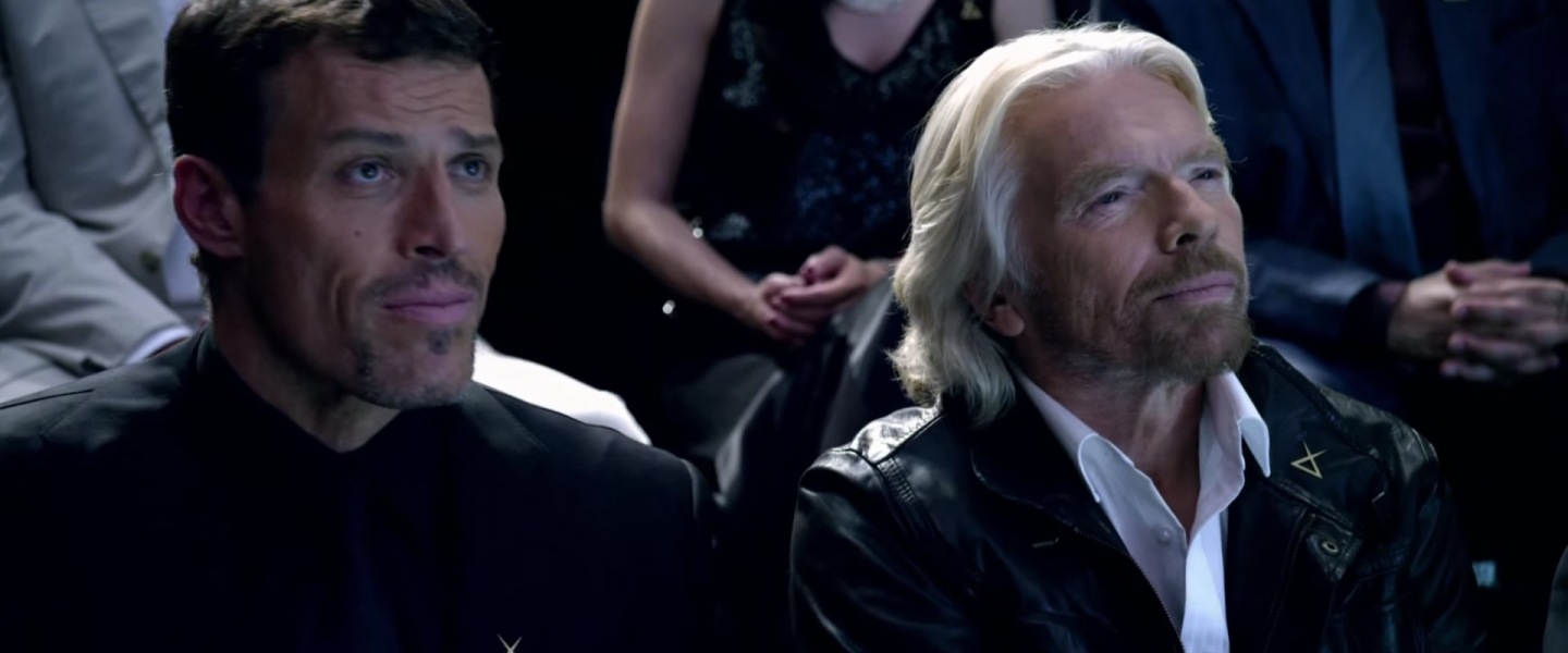 Richard Branson sitting next to Tony Robbins 