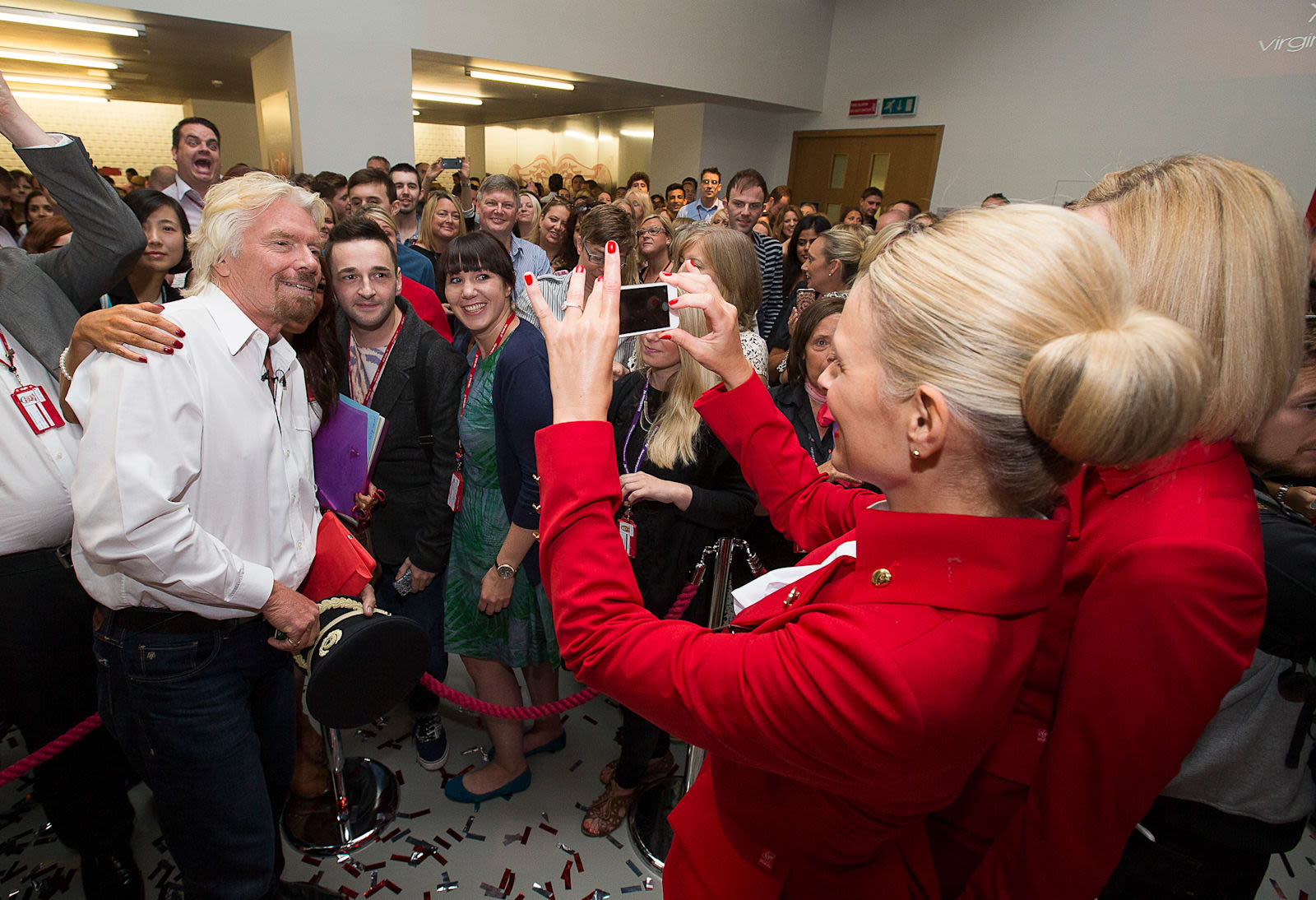 Virgin Atlantic employee taking a picture of Richard Branson and a supporter