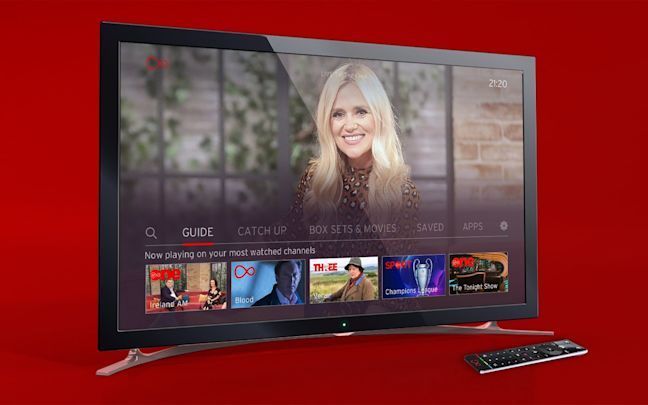 A television with a remote control next to it on a red background A television with a remote control next to it on a red background
