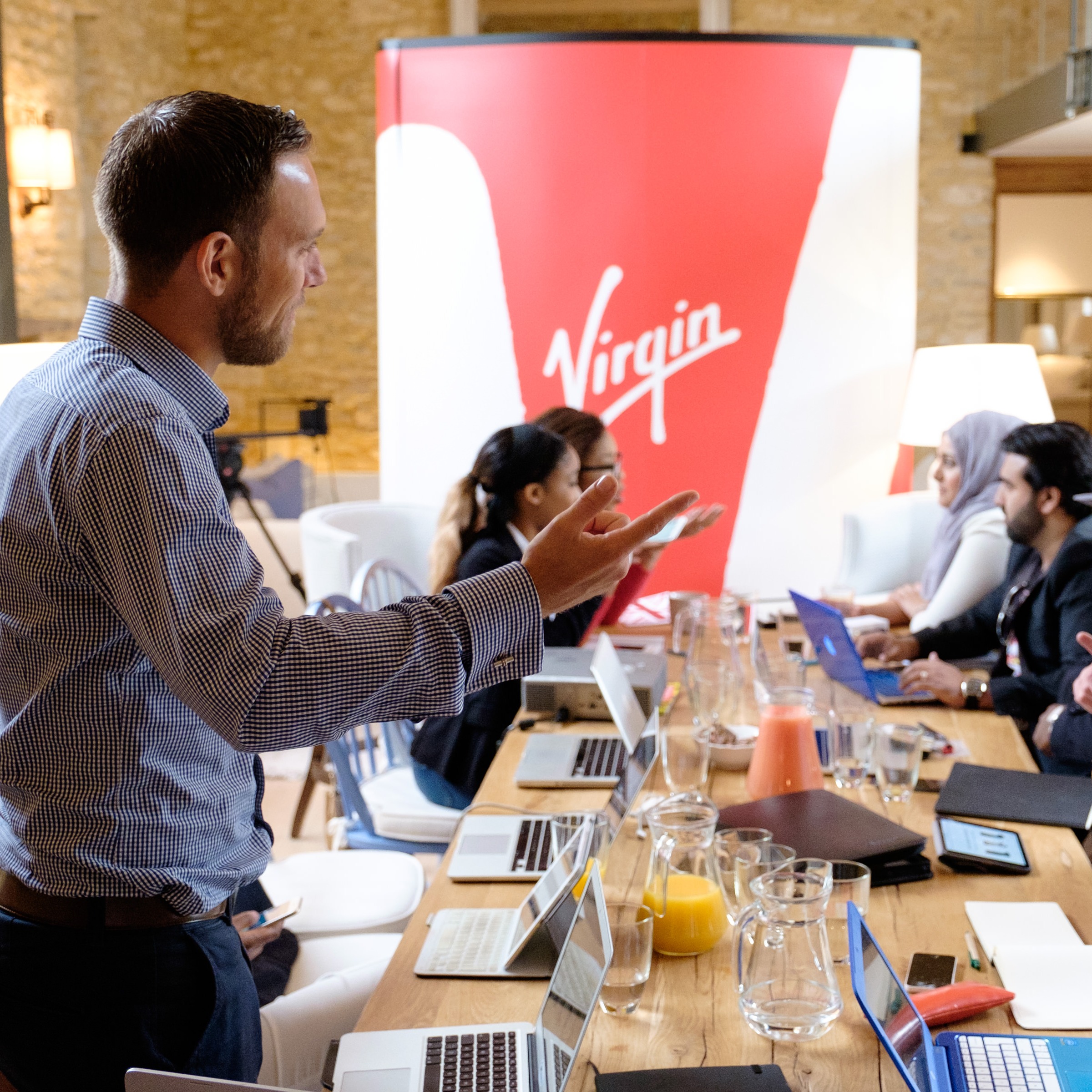 A group of people in discussion around a table