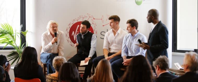 Richard Branson speaking at a panel discussion at the Virgin office in London