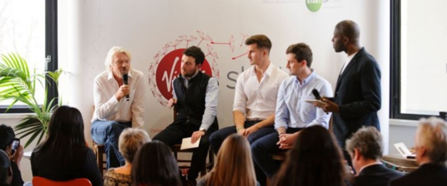 Richard Branson speaking at a panel discussion at the Virgin office in London