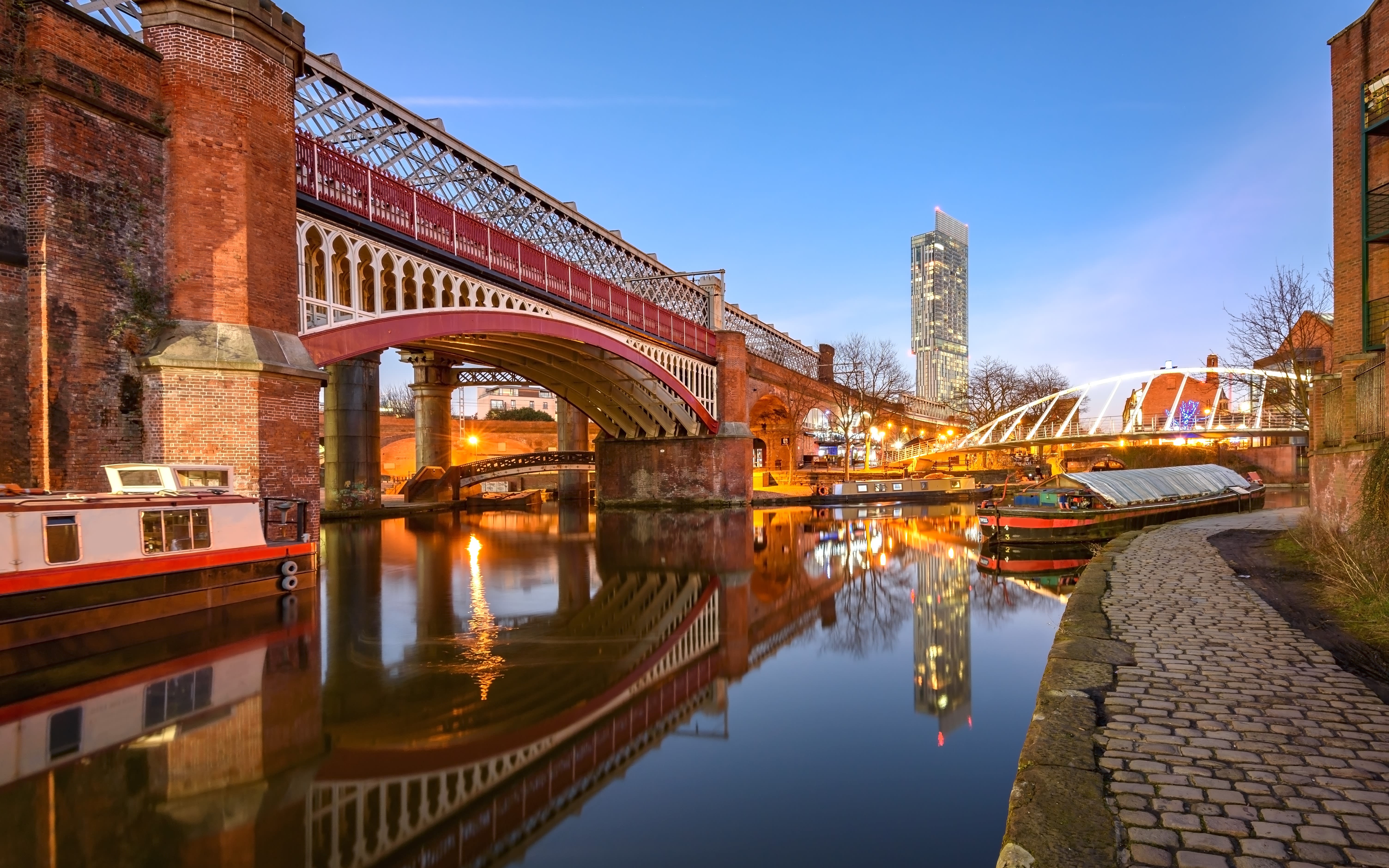 Manchester Cityscape at sunset. Entire city shown with Beetham Tower or the Hilton Hotel in the centre. Aerial view of Manchester city centre. Beautiful city skyline photograph at sunset.