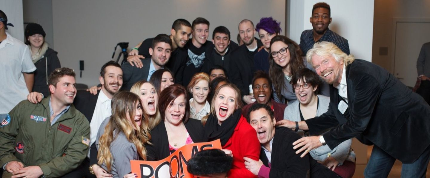 Richard Branson posing happily with Virgin Hotels team