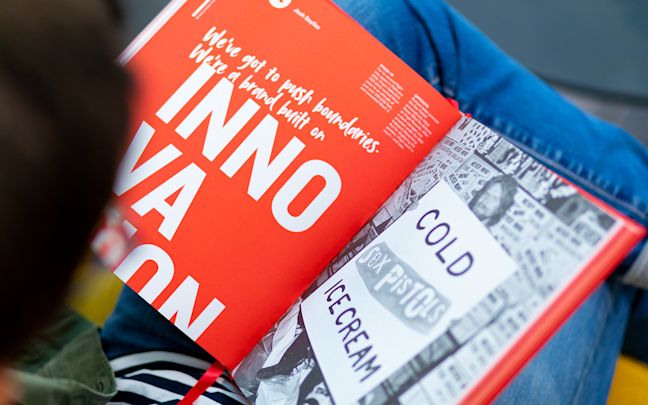 A man reads a copy of Virgin By Design A man reads a copy of Virgin By Design