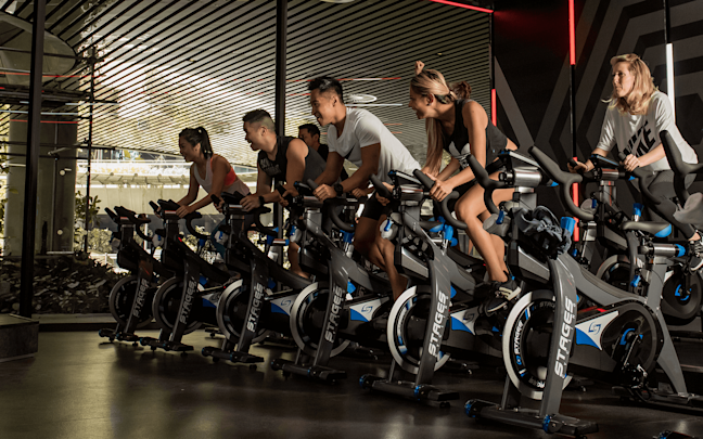 People take part in an indoor cycling class at Virgin Active South Africa People take part in an indoor cycling class at Virgin Active South Africa