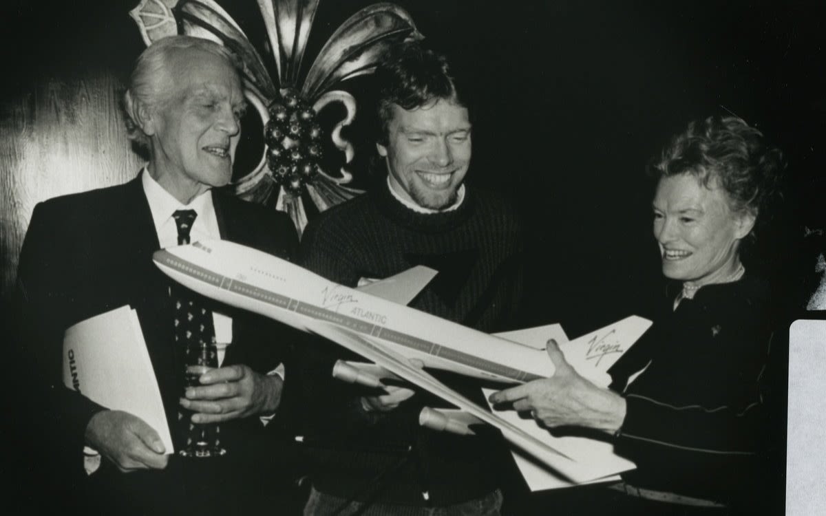 Richard Branson with his parents Ted and Eve holding a model Virgin Atlantic plane