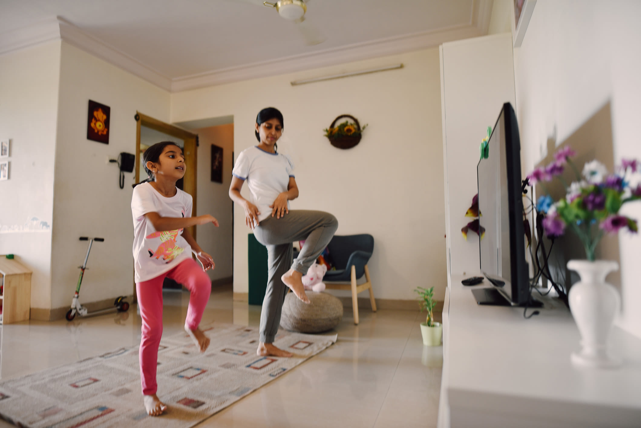A mother and her daughter doing exercise at home