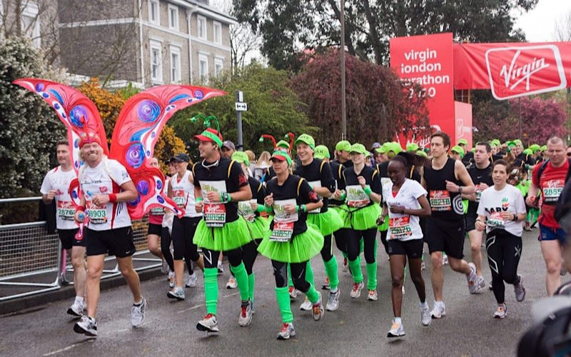 Richard Branson, Sam Branson and Holly Branson run the Virgin Money London Marathon with other members of the Big Change team dressed as a butterfly and caterpillar