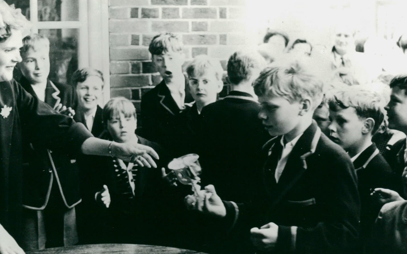 A young Richard Branson at school holding a small trophy