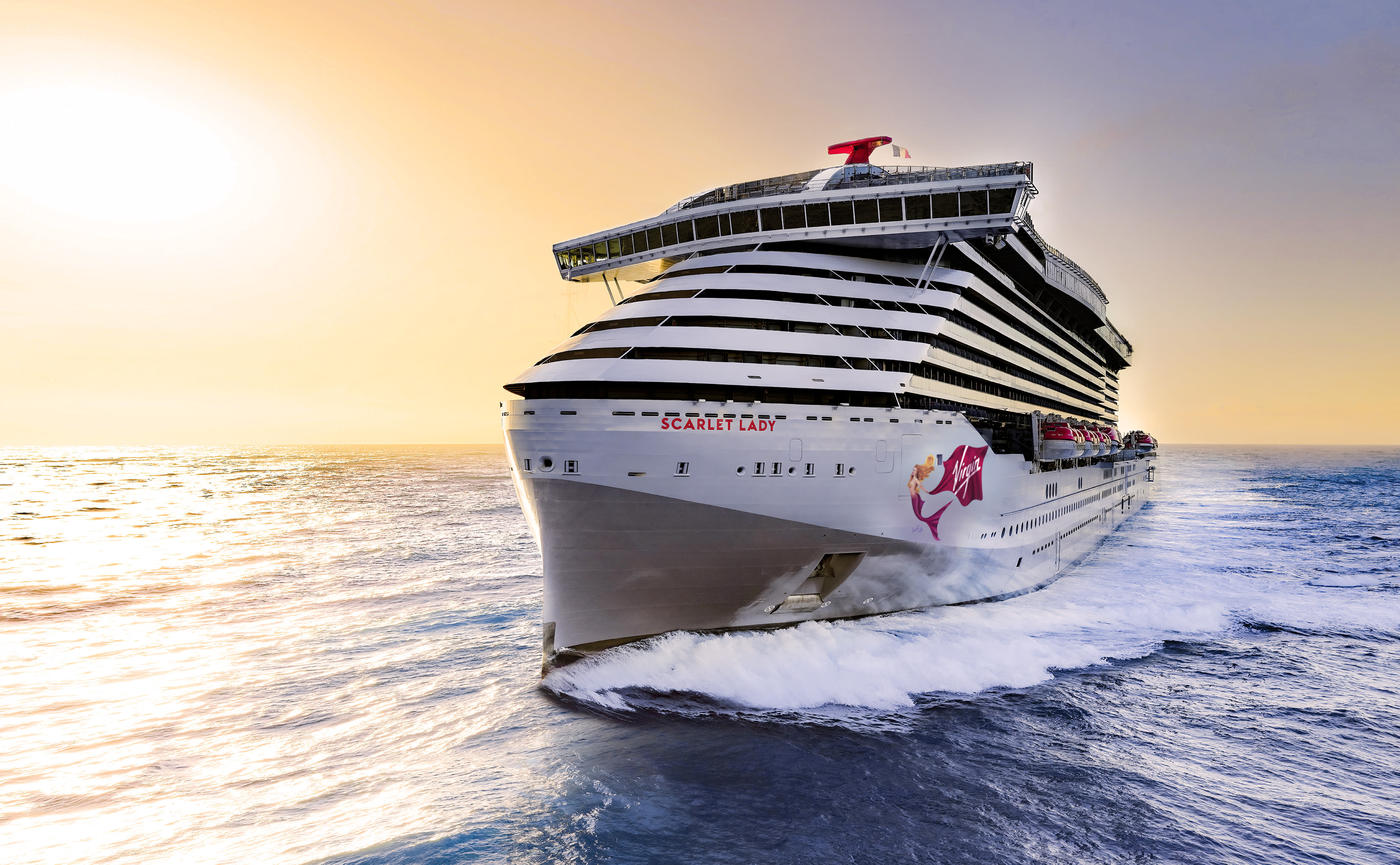 Scarlet Lady, Virgin Voyages' inaugural cruise ship, sailing at sunset
