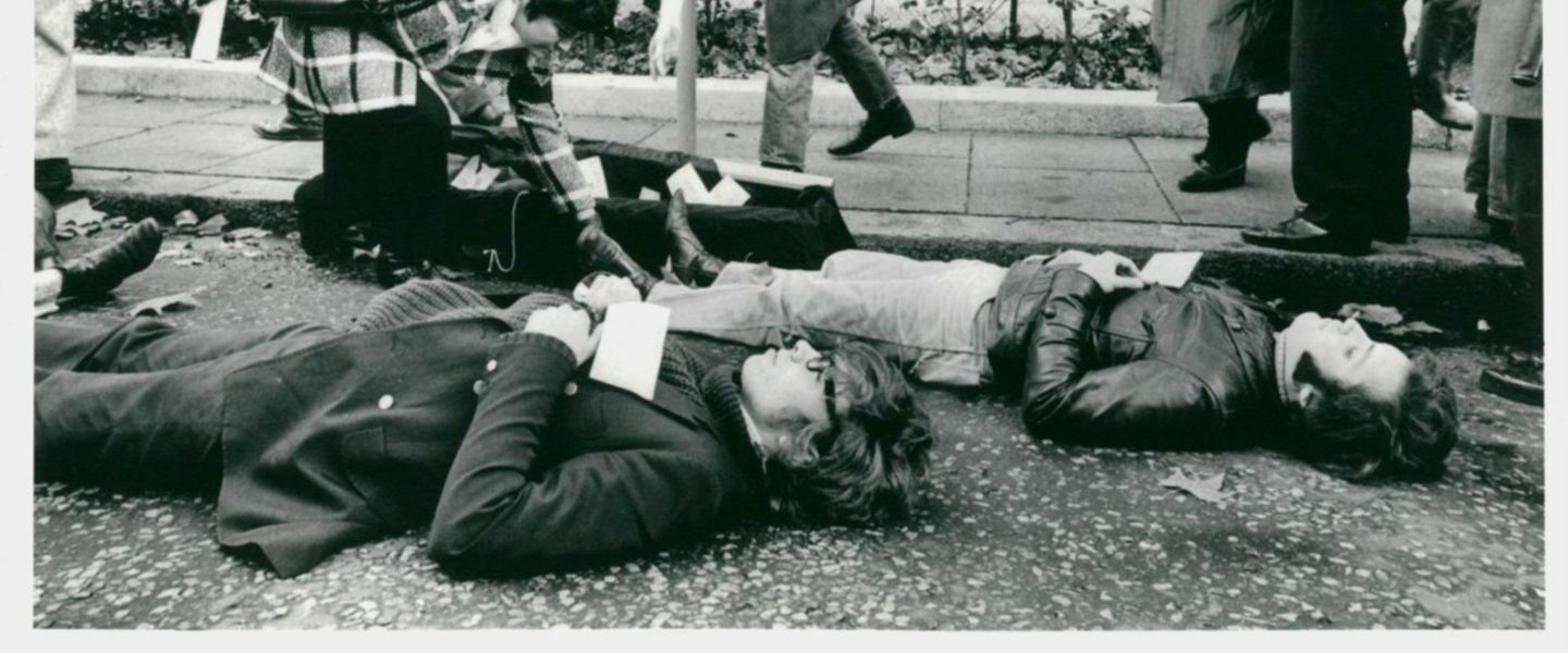 Black and white photo of Richard Branson laying on the floor during a Vietnam protest