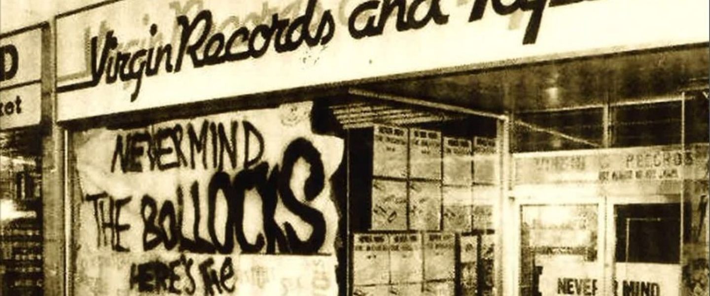 Black and white image of 'Never Mind The Bollocks' sign in-front of Virgin Records store