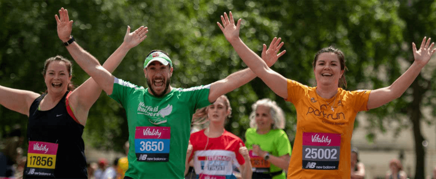 Three people celebrate while running