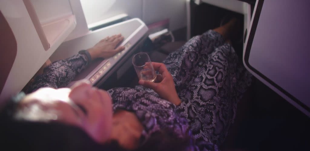 A woman reclining on a Virgin Atlantic plane
