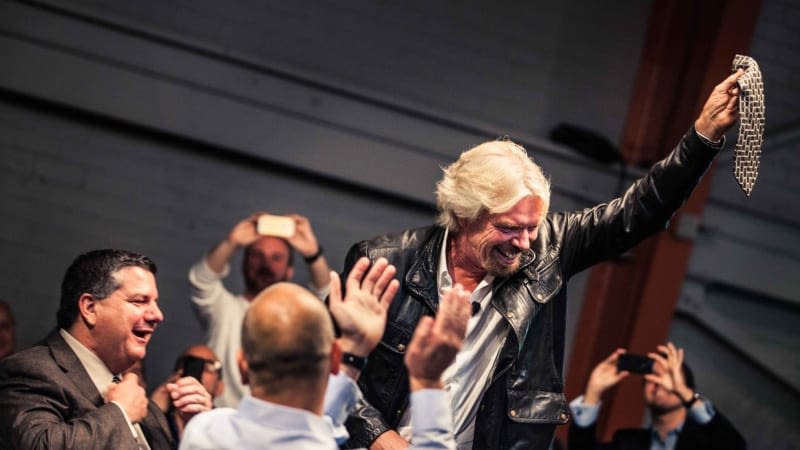 Richard Branson cuts Jim Grubb's tie at a Virgin Disruptors event in San Francisco