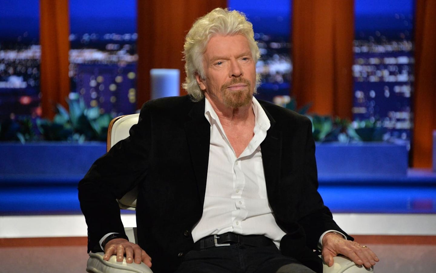 Richard Branson sitting down in armchair